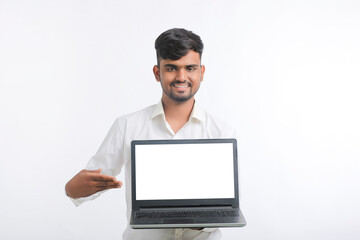 Young indian man showing laptop screen with copy space on white background.