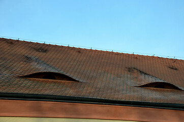 view of the roof made of red brick burnt tiles of the beaver type used in Central Europe on all...