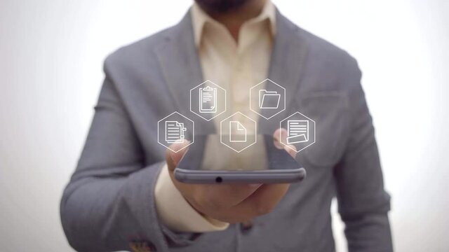 file management concept. businessman holding a smartphone with a hologram of a document.