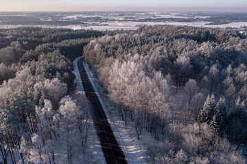 Nice winter road with hoarfrost trees around