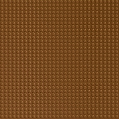Brown plastic constructor blocks plate. Abstract background