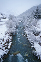 Fototapeta na wymiar Frozen river with fresh snow, Sulden, south tyrol alps