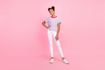 Full body photo of african american girl good mood casual clothes hand waist smile isolated on pink color background