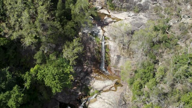 Visitors enjoying the crystal clear and warm waters of Fecha de Barjas waterfall, Peneda-Ger&ecirc;s National Park, Portugal