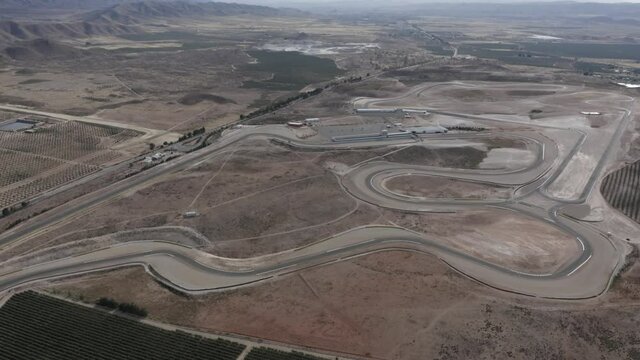Almeria race track from a high angle, full view of the dusty desert surrounding.
