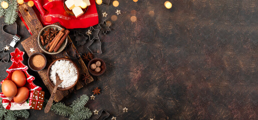 Products for making festive Christmas cookies. Ingredients for spicy cookies on a dark background, top view, web banner with copy space for text