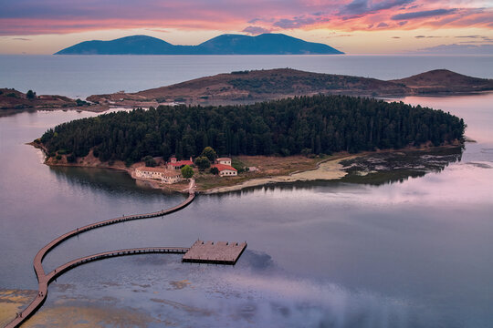 Aerial view of St. Mary's Monastery, Zv&euml;rnec and surroundings. Sunset, colorful sunset sky. Motor home travel concept. Laguna Narte, Albania.