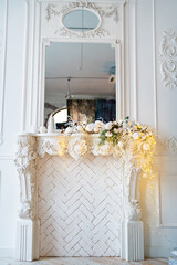 decorative fireplace with mirror decorated with a Christmas wreath and garland 