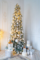 beautiful large elegant Christmas tree with gifts and lanterns in the white room