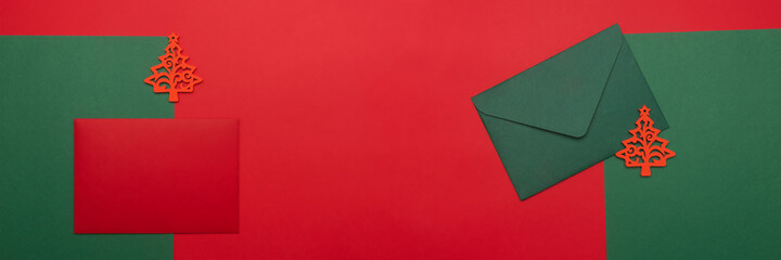 Festive background with two red and green envelopes. Festive background with copyspace. Banner.