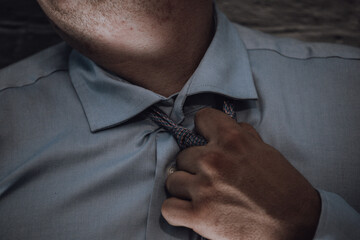 Closeup of a tie on the man's neck.