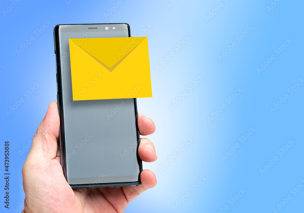 Poster e-mail concept. emails in a smartphone. the envelope icon on the smartphone screen. a person is hold