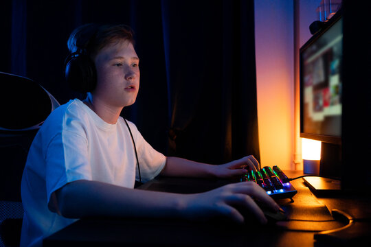Boy playing game on computer at home