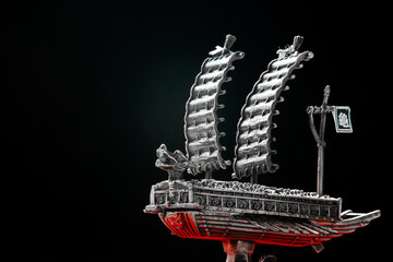 A small model of famous ancient Korean ironclad war ship. Korean turtle ship on a black background....