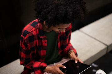 Young african man using tablet at the city. Handsome afro man in subway..