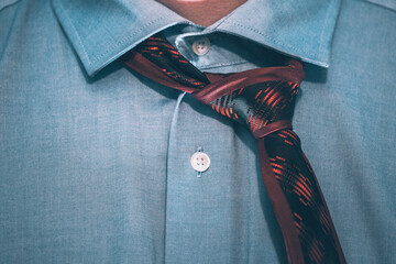 Closeup of a tie on the man's neck.