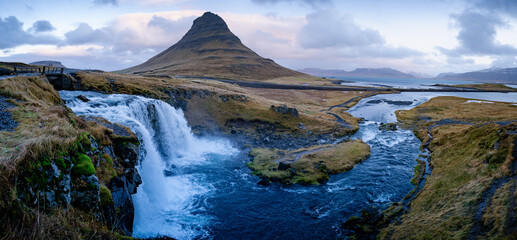 Famous Kirkjufell mountain with cascade waterfalls, Iceland. Kirkjufell is one of the most beautiful natural heritage of Iceland