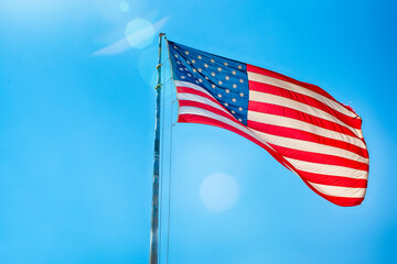 American Travel Destinations. National  American Flag on Pole Against Blue Sky in Arizona in The United States.