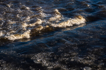 River waves on a sunny, foggy winter morning