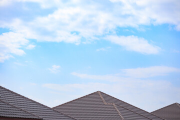 Fototapeta na wymiar Ceramic roof tiles on the house with blue sky