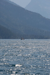 Vertical view of the sea with a ship in the distance.
