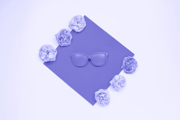 Violet sunglasses and roses on light background. fashion concept.