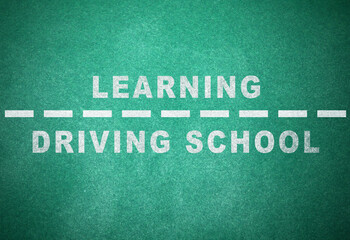 Fototapeta na wymiar Driving school concept. Text and dashed line on green chalkboard