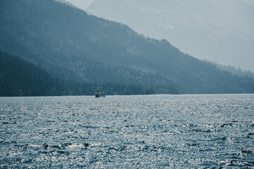 View of the sea surface with a ship in the distance.