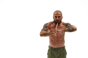 Strong man gesticulating and looking at camera