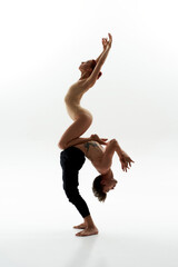Woman sit on belly of partner during ballet dance