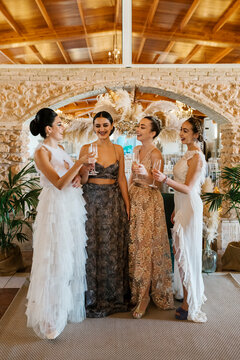Beautiful women talking while holding champagne flute at banquet