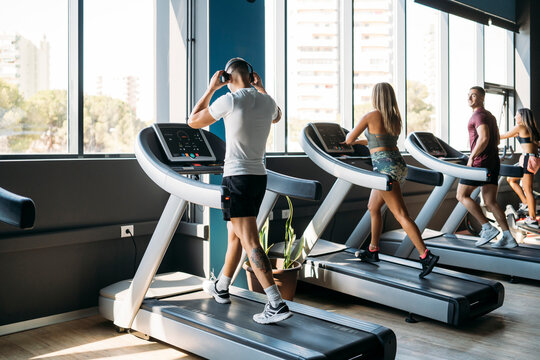 Male and female athlete exercising on treadmill at health club