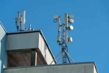New GSM antennas on the roof of a building for transmitting a 5g signal are dangerous to health. Radiation pollution of the environment through cell towers. The threat of extinction of the population