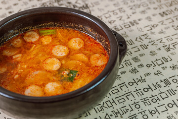 Buddaejjigae, Korean style spicy stew of wieners, luncheon meat, macaroni and vegetables.