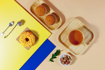Tea with dessert on a bright colored background 