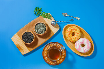 Tea with dessert on a bright colored background 