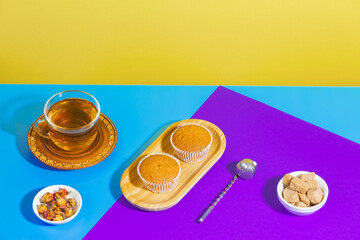 Tea with dessert on a bright colored background 