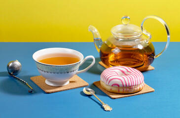 Tea with dessert on a bright colored background 