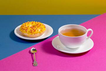 Tea with dessert on a bright colored background 