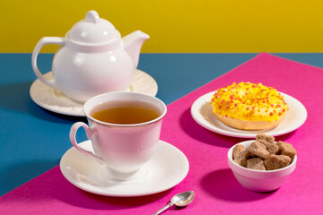 Tea with dessert on a bright colored background 