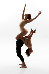 Girl sitting on belly of man during ballet dance