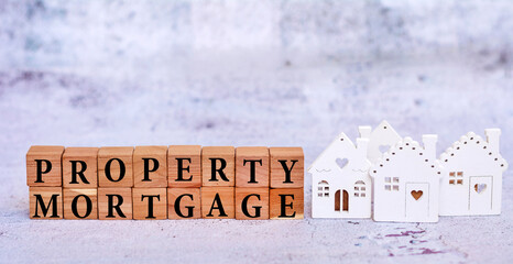 Wooden cubes with the word mortgage and  miniature houses