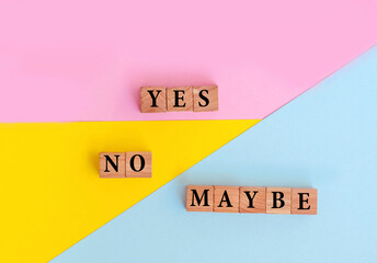 Yes, No and Maybe Words with Wooden Cubes  on Colorful  Background