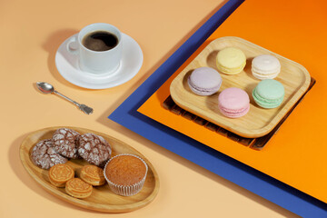 Coffee in a cup in a composition with dessert, on a bright, colorful background.