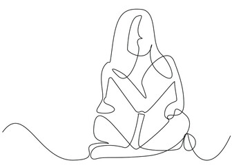 young girl reading a book sitting on the floor with a book in her hand