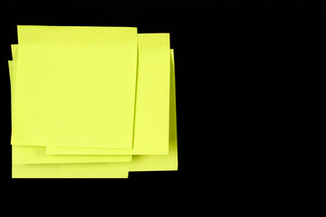 Set of yellow folded note paper sheets on black background