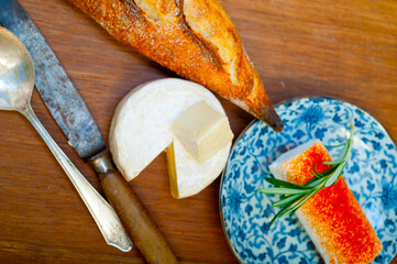 French cheese and fresh  baguette on a wood cutter