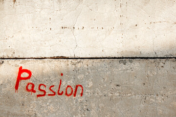 The word PASSION written with red paint on the wall.