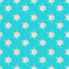 White candy snowflake on blue background. Christmas seamless pattern.