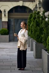 beautiful business woman going to work with coffee